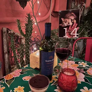 a glass of wine and a bowl of chocolate