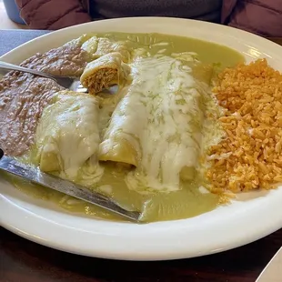 a plate of enchiladas and rice