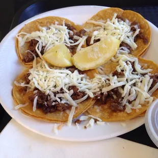 Four asada  tacos with just meat plus I added cheese bombbbbbbb!!!! Lol