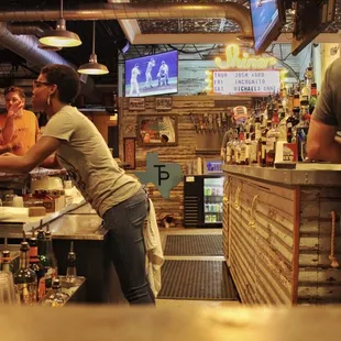 a woman serving a man at a bar