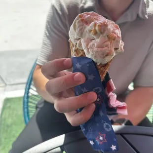 a man holding a cone of ice cream
