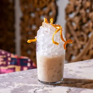 a glass of iced coffee on a table