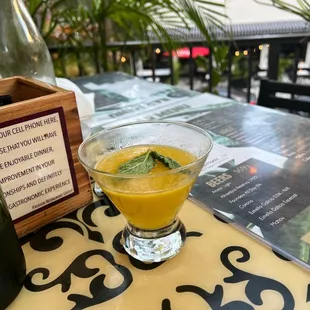 a glass of orange juice on a table