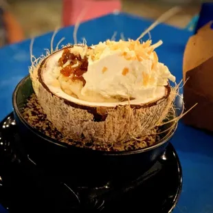 Tres Leches Cake - sponge cake, 3 milks, pineapple compote, toasted coconut, meringue, served in a coconut