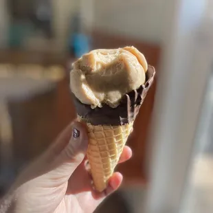 Almond chai vegan ice cream with chocolate dipped waffle cone