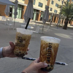 two people holding drinks