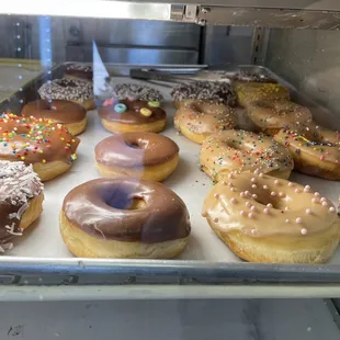 a variety of donuts in a display case