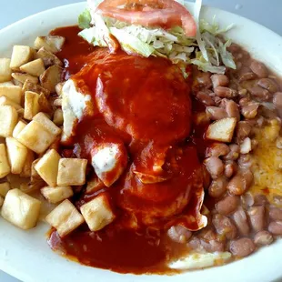 Huevos rancheros over medium, smother in red chile
