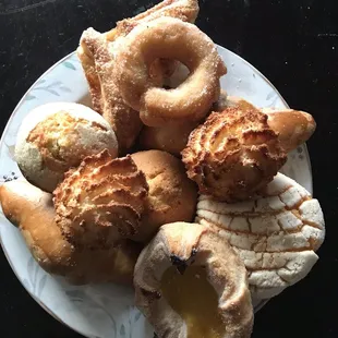 a plate of pastries and doughnuts
