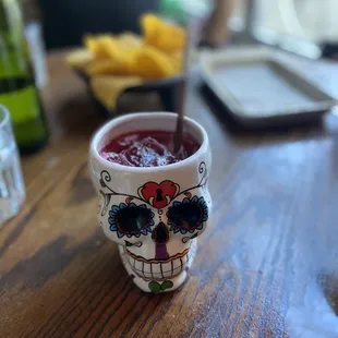 a sugar skull cup with a spoon