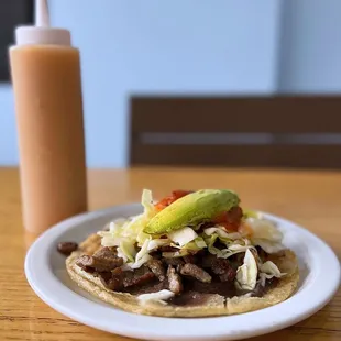 Pork Sabultes: Fried tortilla puff w/ grilled pork, onions, red salsa, cabbage, avocado | $4.50