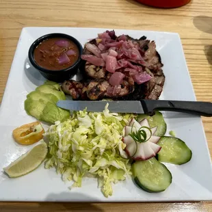 Poc-Chuc (grilled marinated pork) $18 a/o 02/2024. Very tasty! If the salad look wilted it's because they're lightly dressed.