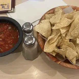 a bowl of chips and a bowl of salsa