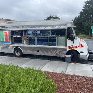 a taco truck parked on the side of the road
