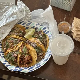 Carnitas, pastor and carne asada tacos and Horchata drink.