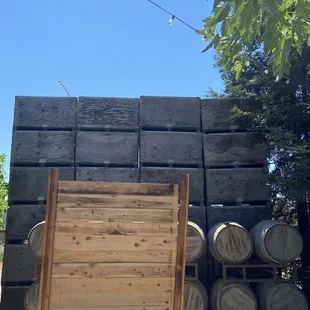 a stack of barrels and a wooden chair