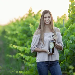a woman holding a bottle of wine