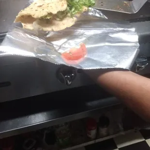a person holding a sandwich