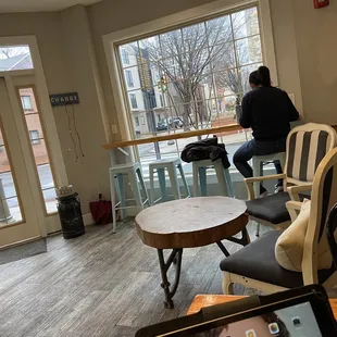 a person sitting at a table with a tablet