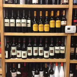 a shelf full of wine bottles
