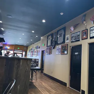 Back area with tables for groups near the kitchen area where one can see the cooks making their awesome meals!