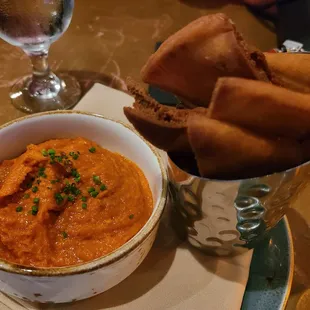 a bowl of hummus and bread