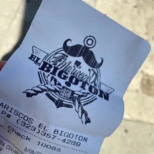 a hand holding a ticket