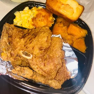 Fried pork-chop , macaroni and cheese, yams , cornbread,and banana pudding .