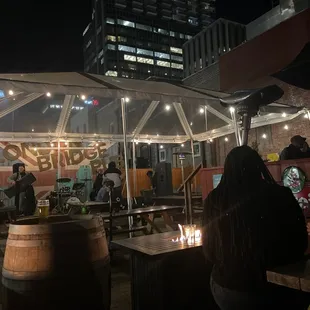 people sitting at tables under umbrellas