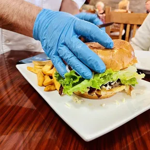 Owner/Chef cutting the burger my colleagues split