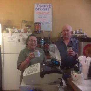 a man and a woman holding a cup of coffee
