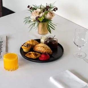 a plate of pastries and a glass of orange juice