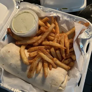 Buffalo chicken wrap with fries to go.