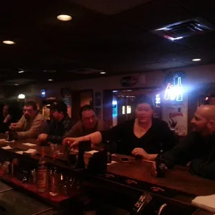 a group of people sitting at a bar