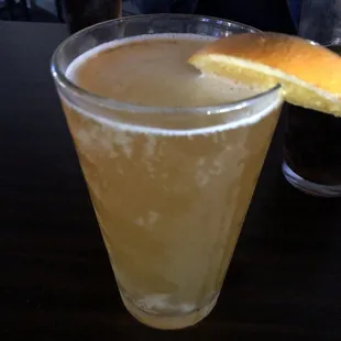 a drink with a slice of orange on the rim