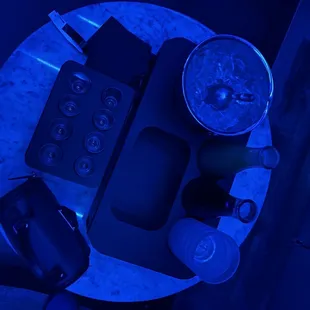 an overhead view of a table with a phone and a cup of coffee