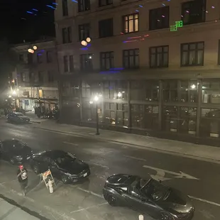 cars parked on a street at night