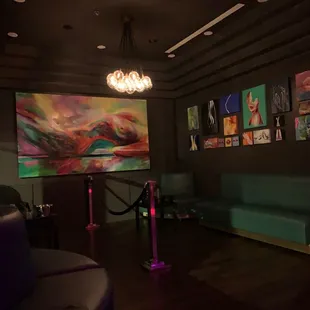 a brightly lit lounge area with art on the wall