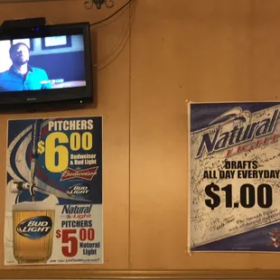 a tv and posters on the wall