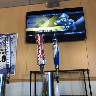beer taps in front of a television