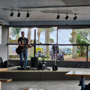 a man on stage with a guitar
