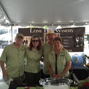 a group of people standing under a tent