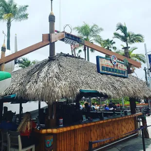 a tiki bar with a thatched roof