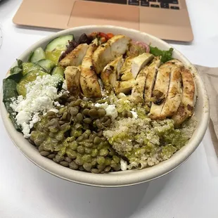 Ancient grains bowl with chicken. Lettuce, quinoa, lentils, cucumber, feta, olives, and a tasty dressing.