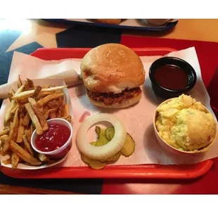 Finger licking good chopped Brisket sandwich with fries and potato salad.