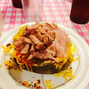Baked potato goodness!
Hiding under the massive amount of ham is butter, sour cream, chives, bacon bits and loads of cheese.