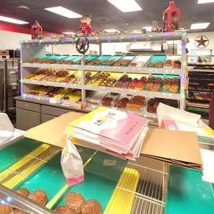 Donuts in their display and owners