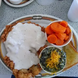 Chicken fried steak with cream gravy, creamed spinach, sweet carrots and toast