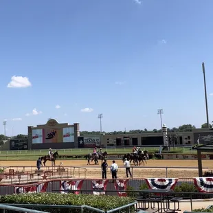 Photo of the track and the horses getting ready for post time.