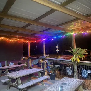 a patio with tables and benches